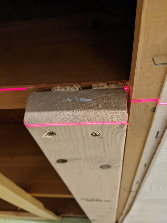 Using a laser level to ensure framing is straight
